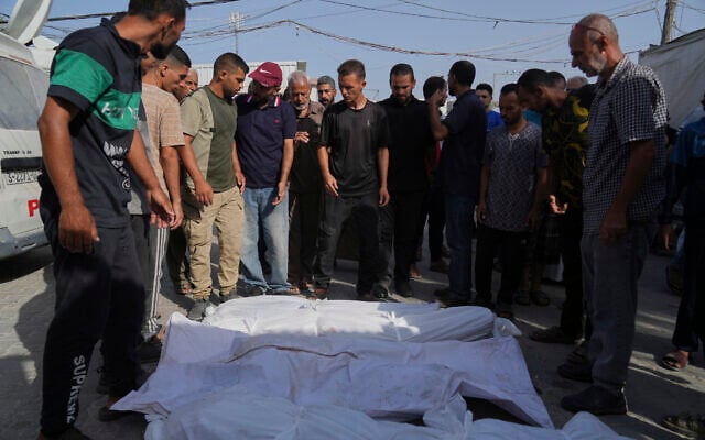 Palestinians stand next to bodies of their relatives, who were killed in an Israeli airstrike, outside the Al-Aqsa Hospital in Deir al-Balah, August 19, 2025. (AP Photo/Abdel Kareem Hana) Palestinians stand next to bodies of their relatives, who were killed in an Israeli airstrike, outside the Al-Aqsa Hospital in Deir al-Balah, August 19, 2025. (AP Photo/Abdel Kareem Hana)