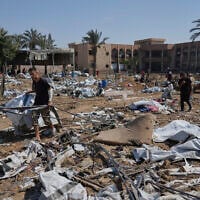 Palestinians check the destruction after Israeli military strikes in a tent camp for displaced people near Al-Aqsa Hospital, in Deir al-Balah, Thursday, August 21, 2025. (AP/Jehad Alshrafi)