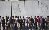 Young Kurdish men line up to sign up to join Syrian government's General Security forces at a police station in Afrin, Syria, an area in the country's north from which Kurds were forcibly displaced years ago, Aug. 21, 2025. (AP Photo/Omar Albam)