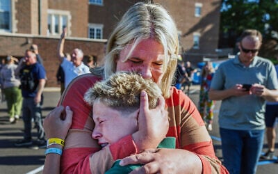 A parent hugs her son during an active shooter situation at the Annunciation Church in Minneapolis, Minnesota, on August 27, 2025. (Richard Tsong-Taatarii/Star Tribune via AP) A parent hugs her son during an active shooter situation at the Annunciation Church in Minneapolis, Minnesota, on August 27, 2025. (Richard Tsong-Taatarii/Star Tribune via AP)
