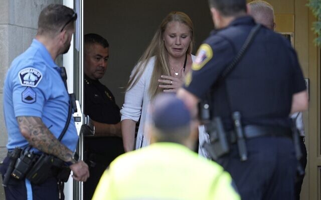 A person walks out of the Annunciation Church's school as police response to a reported mass shooting, Wednesday, Aug. 27, 2025, in Minneapolis. (AP Photo/Abbie Parr)