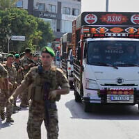 Lebanese army soldiers escort trucks carrying weapons handed over by Palestinian factions from Rashidiyeh refugee camp to the Lebanese army, as they pass in Tyre city, south Lebanon, August 28, 2025. (AP/Mohammed Zaatari)