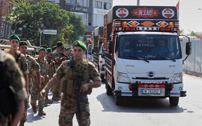 Lebanese army soldiers escort trucks carrying weapons handed over by Palestinian factions from Rashidiyeh refugee camp to the Lebanese army, as they pass in Tyre city, south Lebanon, August 28, 2025. (AP/Mohammed Zaatari)