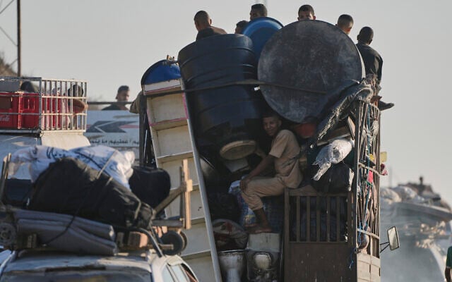 Palestinians fleeing the northern Gaza Strip move with their belongings along the Sea Road, near Wadi Gaza on August 30, 2025. (AP/Abdel Kareem Hana)