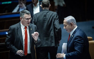 Prime Minister Benjamin Netanyahu, right, speaks with Foreign Affairs Minister Gideon Sa'ar during a debate in the Knesset on March 26, 2025. (Yonatan Sindel/Flash90)