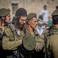 Ultra-Orthodox soldiers from the IDF's new Haredi Hasmonean Brigade take part in a beret march after completing seven months of basic and advanced training, at the Western Wall in Jerusalem's Old City, on August 6, 2025. (Chaim Goldberg/Flash90)
