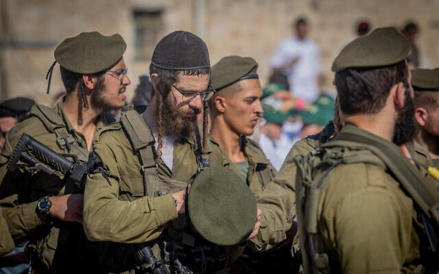 Ultra-Orthodox soldiers from the IDF's new Haredi Hasmonean Brigade take part in a beret march after completing seven months of basic and advanced training, at the Western Wall in Jerusalem's Old City, on August 6, 2025. (Chaim Goldberg/Flash90)