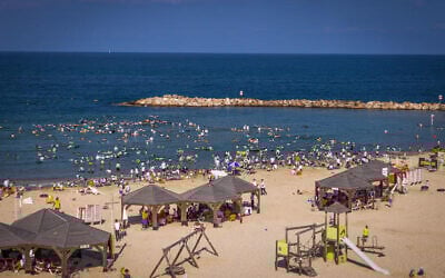 As an extreme heatwave takes hold, hundreds of ultra-Orthodox men and children enjoy the sea at Tel Aviv's religious beach, August 8, 2025. (Flash90)