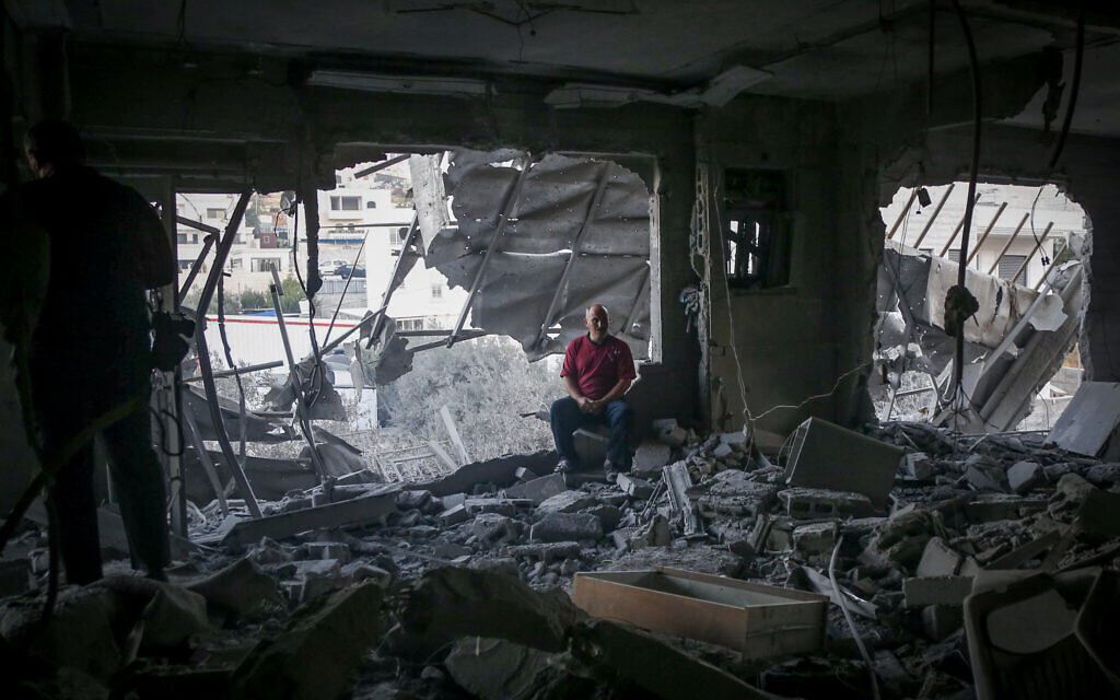 Palestinians walk in the rubble of the Hebron home of a Palestinian assailant razed by the army overnight, on August 7, 2025. (Wisam Hashlamoun/FLASH90)
