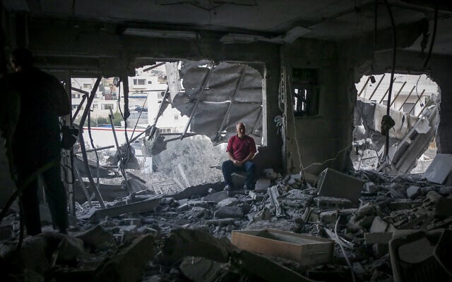 Palestinians walk in the rubble of the Hebron home of a Palestinian assailant razed by the army overnight, on August 7, 2025. (Wisam Hashlamoun/FLASH90) Palestinians walk in the rubble of the Hebron home of a Palestinian assailant razed by the army overnight, on August 7, 2025. (Wisam Hashlamoun/FLASH90)