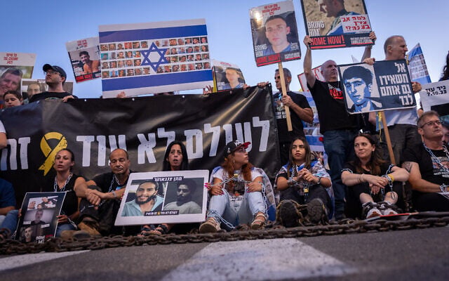 Einav Zangauker (3rd left) holds images of her son, Matan, at a protest calling for the end of the war in Gaza and the release of all hostages, in Jerusalem, August 7, 2025. (Yonatan Sindel/FLASH90) Einav Zangauker (3rd left) holds images of her son, Matan, at a protest calling for the end of the war in Gaza and the release of all hostages, in Jerusalem, August 7, 2025. (Yonatan Sindel/FLASH90)