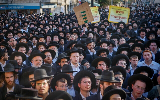 Ultra-Orthodox Jewish men block a road during a protest against the jailing of yeshiva students who failed to comply with an army recruitment order, in Jerusalem on August 7, 2025. (Yonatan Sindel/Flash90)