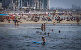 People enjoy at the beach in Tel Aviv, August 9, 2025. (Avshalom Sassoni/Flash90)