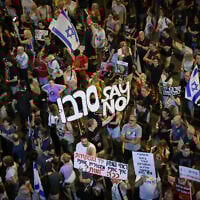 Anti-government, pro-hostage deal protesters hold a sign urging IDF soldiers to refuse to carry out a decision to take over Gaza City, outside the Kirya military headquarters in Tel Aviv, August 9, 2025. (Miriam Alster/Flash90)