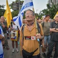 Former and reserve air force pilots, along with others, demonstrate against the continuation of the Gaza war and for the release of hostages held in the Strip, near the Kirya military base in Tel Aviv, on August 12, 2025. (Avshalom Sassoni/Flash90)