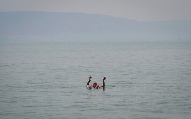 An Israeli floats in the Sea of Galilee amid a heatwave on August 14, 2025. (Michael Giladi/Flash90)