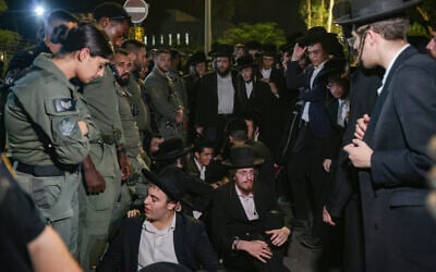 Haredi men attend a rally against the jailing of Jewish seminary students who failed to comply with an army recruitment order, outside the military prison in Beit Lid, near Netanya, August 14, 2025. (Tal Gal/Flash90)