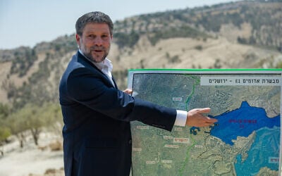 Finance Minister Bezalel Smotrich attends a press conference announcing his plans to approve more than 3,000 housing units in the E1 West Bank settlement project between Jerusalem and Ma’ale Adumim on August 14, 2025. (Yonatan Sindel/Flash90) Finance Minister Bezalel Smotrich attends a press conference announcing his plans to approve more than 3,000 housing units in the E1 West Bank settlement project between Jerusalem and Ma’ale Adumim on August 14, 2025. (Yonatan Sindel/Flash90)