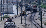 Workers repair railway tracks after a shutdown caused by heavy damage to electric cable infrastructure, in Tel Aviv, August 16, 2025.(Avshalom Sassoni/Flash90)