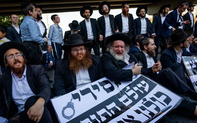 Ultra-Orthodox protesters clash with police during a protest against the drafting of Haredi men to the military, on Route 4 near Bnei Brak, August 19, 2025. They hold a sign reading: "Prisoners from the Torah world: We are with you," referring to jailed draft-dodgers. (Yonatan Sindel/Flash90) Ultra-Orthodox protesters clash with police during a protest against the drafting of Haredi men to the military, on Route 4 near Bnei Brak, August 19, 2025. They hold a sign reading: "Prisoners from the Torah world: We are with you," referring to jailed draft-dodgers. (Yonatan Sindel/Flash90)