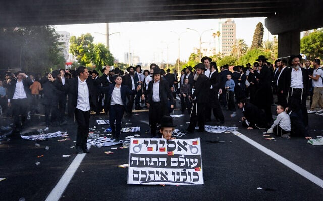 Ultra-Orthodox protesters against the drafting of yeshiva students to the military block Route 4, near Bnei Brak, August 19, 2025. (Yonatan Sindel/Flash90) Ultra-Orthodox protesters against the drafting of yeshiva students to the military block Route 4, near Bnei Brak, August 19, 2025. (Yonatan Sindel/Flash90)