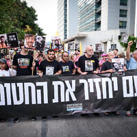 Israelis hold a protest march in Tel Aviv calling for an end to the war in Gaza and a safe return of hostages held by Hamas, August 21, 2025. The banner reads: The people will return the hostages. (Avshalom Sassoni/Flash90)