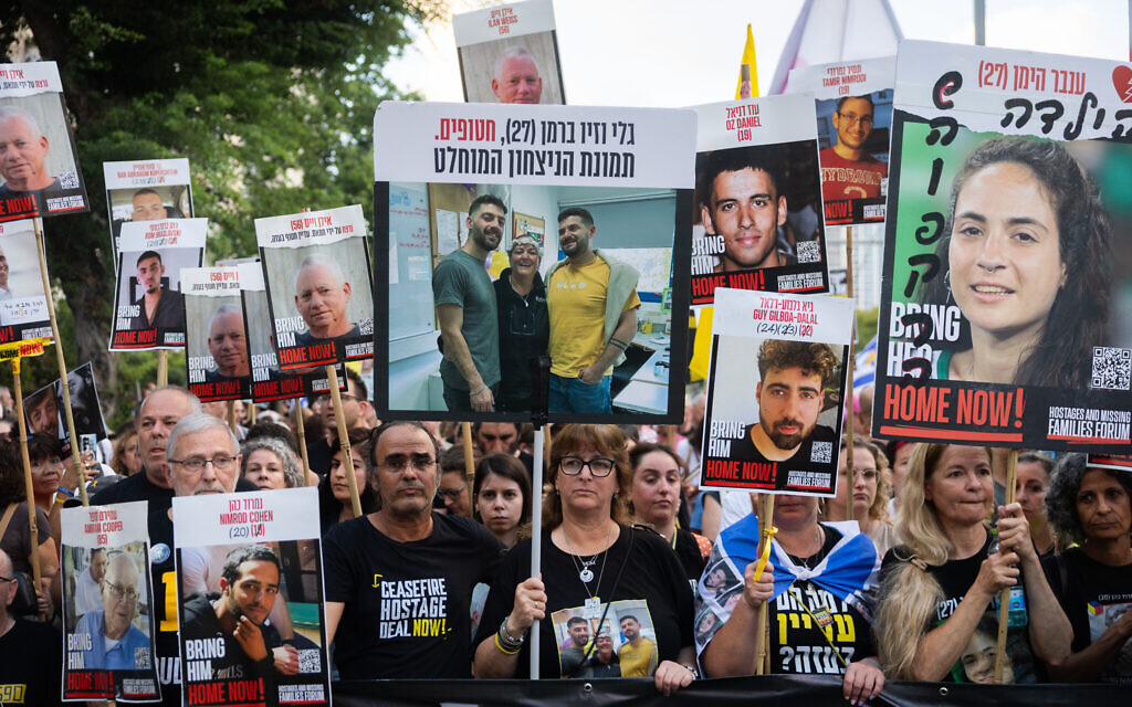 Families of hostages, living and dead, who are held in the Gaza Strip, and supporters, march in Tel Aviv calling for a deal to secure their return, August 26, 2025. (Chaim Goldberg/Flash90)