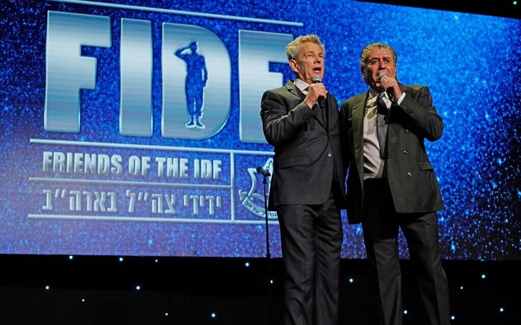 Record producer David Foster, left, and entertainment executive Haim Saban speak onstage at the Friends of the Israel Defense Forces Western Region Gala at The Beverly Hilton Hotel in Beverly Hills, California, November 1, 2018. (Shahar Azran/Getty Images via JTA) Record producer David Foster, left, and entertainment executive Haim Saban speak onstage at the Friends of the Israel Defense Forces Western Region Gala at The Beverly Hilton Hotel in Beverly Hills, California, November 1, 2018. (Shahar Azran/Getty Images via JTA)