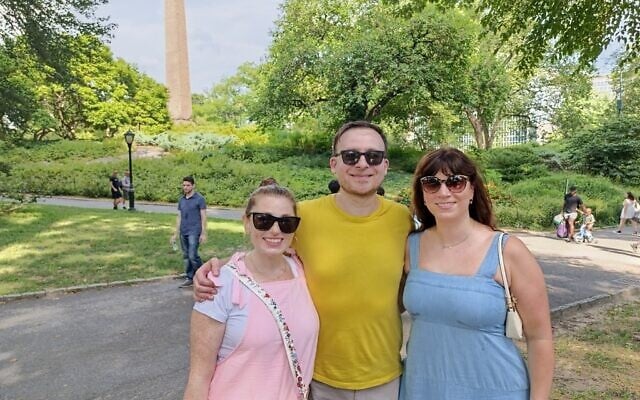 Jewish Social Community (JSC) founder Arkadiy Kantor (center) with volunteers Hindy (R) and Samantha, at a JSC picnic in Central Park, August 17, 2025. (Zev Stub/Times of Israel)