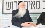 MK Meir Porush sits in a protest tent outside the Justice Ministry in Jerusalem, August 12, 2025. (Sam Sokol/Times of Israel)