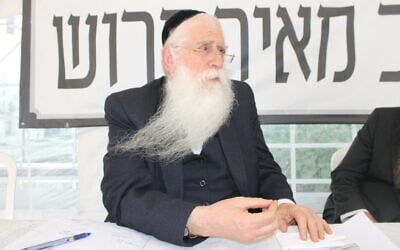 MK Meir Porush sits in a protest tent outside the Justice Ministry in Jerusalem, August 12, 2025. (Sam Sokol/Times of Israel)