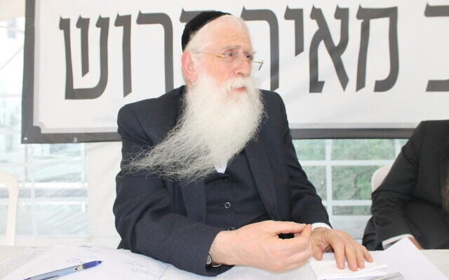 MK Meir Porush sits in a protest tent outside the Justice Ministry in Jerusalem, August 12, 2025. (Sam Sokol/Times of Israel)