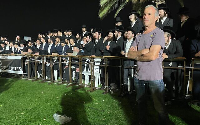 Yesh Atid MK Elazar Stern, right, attends the scene of an ultra-Orthodox rally against the arrest of draft-dodging yeshiva students outside of the military prison at Beit Lid, August 14, 2025. (Sam Sokol/Times of Israel)