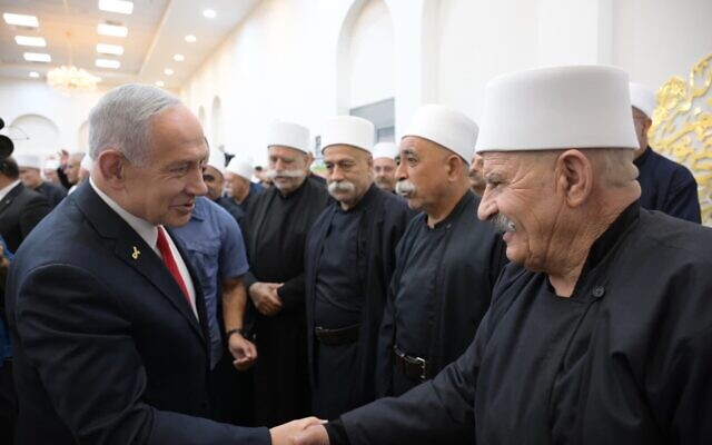 Prime Minister Benjamin Netanyahu meets Druze leaders in Julis on August 28, 2025. (Amos Ben Gershom/GPO)