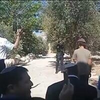 National Security Minister Itamar Ben Gvir, wearing a white kippa, takes part in a Jewish prayer service on the flashpoint Temple Mount in Jerusalem's Old City, August 3, 2025. (X video screenshot:  used in accordance with Clause 27a of the Copyright Law)