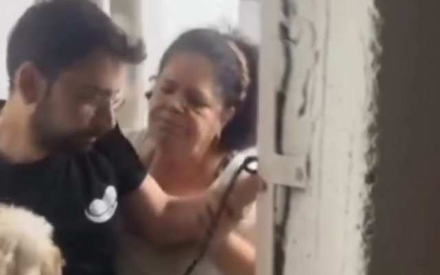 Liliana Laniado, a resident of Bat Yam, blocks one of her neighbors from entering a bomb shelter during an Iranian missile attack on June 22, 2025. (Screenshot/X)