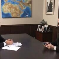 Prime Minister Benjamin Netanyahu looks at an amulet showing "a map of the Promised Land," given to him by his interviewer, August 12, 2025. (Screenshot i24 news) 