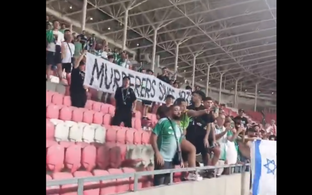 Maccabi Haifa fans display banner reading "Murderers since 1939" at match against a Polish club in Hungary, August 15, 2025. (Screenshot/X)