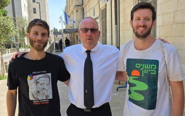 Jerusalem protesters Rom Leor (left) and Matanel Ciechanowski (right) with their lawyer Yoni Nussbaum (center) after being released from police custody in the Jerusalem Magistrate's Court on August 18, 2025. (Courtesy) Jerusalem protesters Rom Leor (left) and Matanel Ciechanowski (right) with their lawyer Yoni Nussbaum (center) after being released from police custody in the Jerusalem Magistrate's Court on August 18, 2025. (Courtesy)