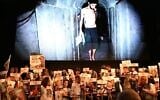 Protesters hold posters of the hostages in front of a still image taken from a Hamas video of hostage Evyatar David, on August 2, 2025. (Paulina Patimer/ Hostages and Missing Families Forum)