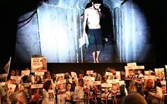 Protesters hold posters of the hostages in front of a still image taken from a Hamas video of hostage Evyatar David, on August 2, 2025. (Paulina Patimer/Hostages and Missing Families Forum)