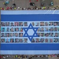 A giant Israeli flag emblazoned with the faces of the hostages is displayed at Hostages Square in Tel Aviv, as a national strike gets underway, on August 17, 2025. (Yair Palti/Hostages and Missing Families Forum)