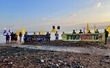 Protesters hold banners calling for the release of the hostages on the shore of the Sea of Galilee, on August 17, 2025. (October Council)