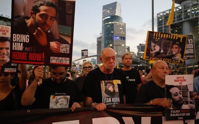Itzik Horn, father of hostage Eitan Horn and captivity survivor Yair Horn, leads protestors around the IDF headquarters in Tel Aviv on August 21, 2025. (Yoav Loeff/protest movement)