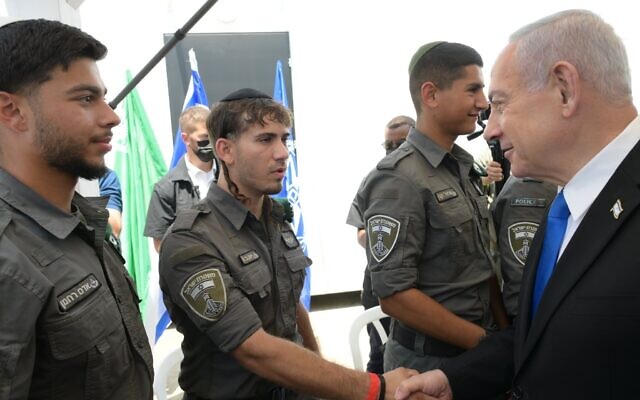 Prime Minister Benjamin Netanyahu, right, visits a new Border Police company for ultra-Orthodox men, August 14, 2025. (Amos Ben Gershom/GPO)