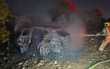 Firefighters work to extinguish burning vehicle in Horshim Forest near Kfar Qasim on August 23, 2025 (Israel Fire and Rescue Services)