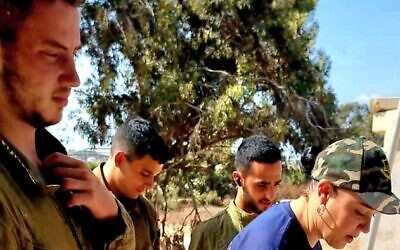(L-R) Omer Neutra, Oz Daniel, Nimrod Cohen and Tsipora Halfon, the volunteer chair of the Association for the Welfare of Israeli Soldiers, in footage taken at the so-called 'White House' IDF post next to Kibbutz Nirim days before the former three were attacked and taken hostage on October 7, 2023, with Neutra and Daniel killed. (Screenshot: Tsipora Halfon/courtesy) (L-R) Omer Neutra, Oz Daniel, Nimrod Cohen and Tsipora Halfon, the volunteer chair of the Association for the Welfare of Israeli Soldiers, in footage taken at the so-called 'White House' IDF post next to Kibbutz Nirim days before the former three were attacked and taken hostage on October 7, 2023, with Neutra and Daniel killed. (Screenshot: Tsipora Halfon/courtesy)