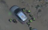 Men, whom the military says are terror operatives, gather around a vehicle emblazoned with the emblem of the World Central Kitchen, in central Gaza, in footage published August 12, 2025. The WCK verified the men were not connected to the NGO, the army said. (Israel Defense Forces)