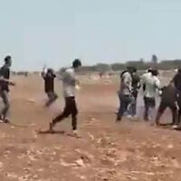 A Palestinian man throws a stone during a clash near the West Bank town of Duma, August 13, 2025. (Screenshot: X; used in accordance with Clause 27a of the Copyright Law)