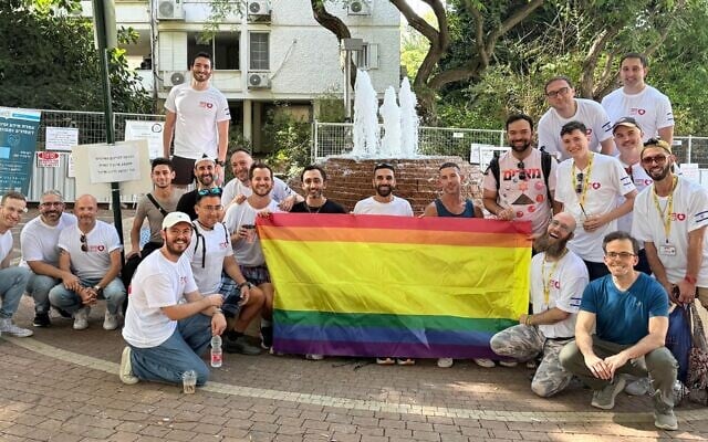A group from a delegation organized by Hebro and Birthright Israel pose after clearing out an apartment damaged by an Iranian ballistic missile in Ramat Aviv, Israel, in August 2025. (Photo by Gali Gordon via JTA)